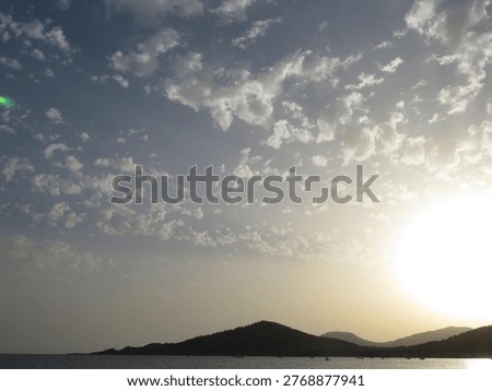Sunset over mountains with spectacular cloud patterns