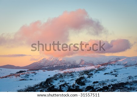 Sunset over Mt Bogong, the highest point in the Victorian Alps, Australia, after early autumn snowfall
