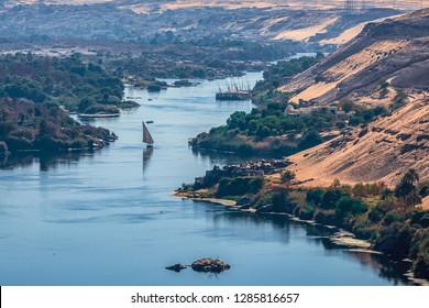 Sunset over the Nile River in the city of Aswan with sandy and deserted shores - Shutterstock ID 1285816657