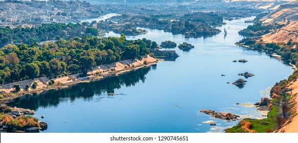 Sunset over the Nile River in the city of Aswan with sandy and deserted shores - Shutterstock ID 1290745651