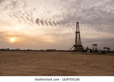 Sunset Over Oil Field And Rig