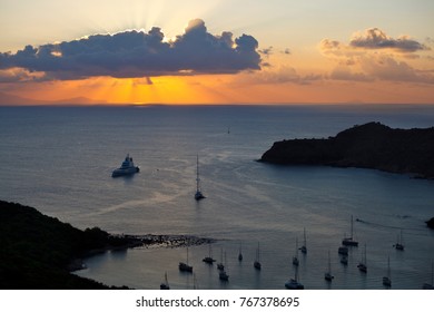 Sunset Over A Part Of English Harbour In Antigua. The Island At Horizon Is Montserrat.