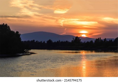 Sunset over the river in the forest. Sundown on mountain hill