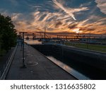 Sunset over Sault Locks as a freighter sails inro Lake Superior