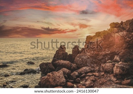 Sunset over the sea horizon and coastal cliff beach. Sea cliff on coastal beach, with a beautiful sky view