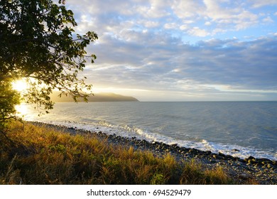 Sunset Over The Sea Off The Captain Cook Highway Between Cairns And Mossman In Far North Queensland, Australia