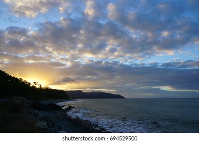 Sunset Over The Sea Off The Captain Cook Highway Between Cairns And Mossman In Far North Queensland, Australia