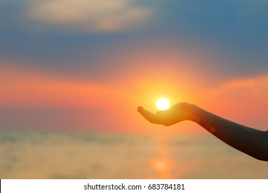 Sunset Over The Sea. The Sun In A Child's Hand.