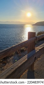 Sunset Over The Sea And Wooden Fencing.