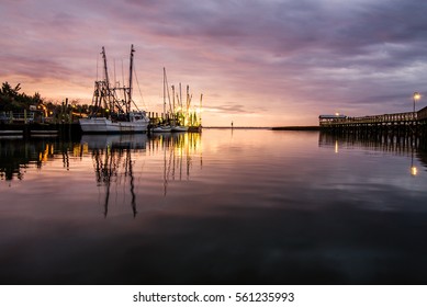 Sunset over Shem Creek in Mount Pleasant, South Carolina with the fishing boats in the distance.  - Shutterstock ID 561235993