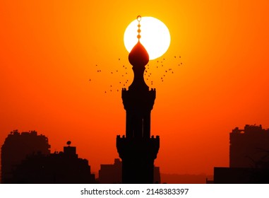 Sunset over the sky of Cairo, an ancient minaret dating back a thousand years, the minaret of Al-Tanbagha Al-Mardani Mosque | downtown Cairo