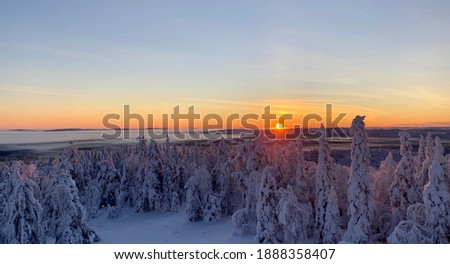 Sunset over a snow covered landscap in north of Sweden at the polar cirlcle