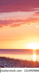 Sunset over a stone beach with dramatic colors and clouds. Hittarps revet in Helsingborg, Sweden is an unknown beauty. 