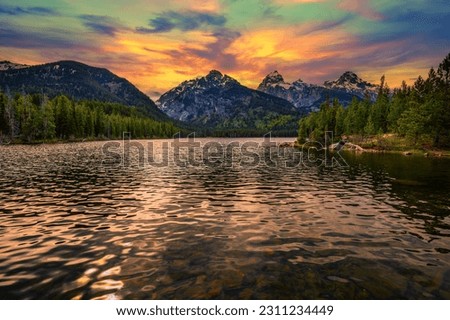 Sunset over Taggart Lake and Grand Teton Mountains in Wyoming, USA. Taggart Lake is a stunning alpine lake in Grand Teton National Park, surrounded by majestic mountains.