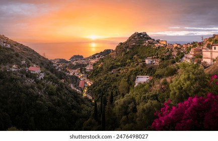 Sunset over Taormina, Sicily, showcasing the picturesque hillside village and Mediterranean scenery. - Powered by Shutterstock