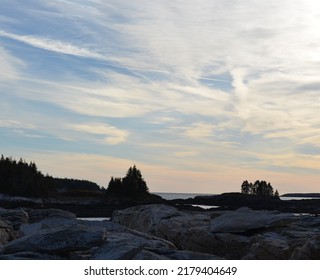 Sunset Over Trees And Rocks On The Coast Of Maine