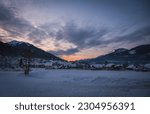 Sunset over Troepolach and Rattendorf. Lower station of the ski lift on Nassfeld ski resort. Carinthia, Austria. January 2022