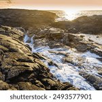 Sunset Over The Volcanic Shoreline at Hokulia Shoreline Park, Hawaii Island, Hawaii, USA