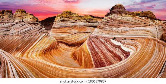 Sunset over the Wave in Arizona in the USA. The Wave is an awesome vivid swirling petrified dune sandstone formation in Coyote Buttes North. Panoramic photo