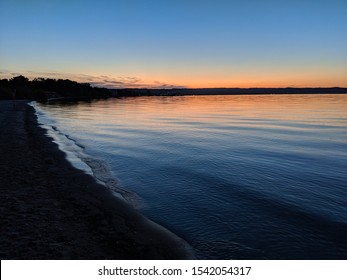 Sunset Over West Grand Traverse Bay In Traverse City, Michigan Take From Clinch Park