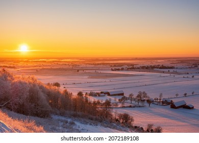 Sunset over a wintry rural landscape