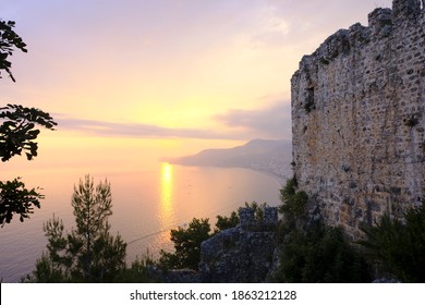 Sunset overlooking the sea, next to the fortress, beautiful landscape in the Mediterranean waters. Nature, sunny summer light