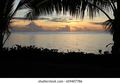 Sunset With Palm Trees Over Samoan Bay.