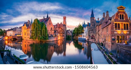 Sunset panorama of center of Bruges, often referred to as The Venice of the North, with famous Rozenhoedkaai. Belgium