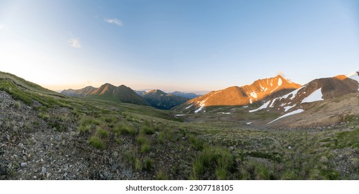 Sunset panoramic views over back country area near Paddy Peak on the Alaska Canada border during summer time with bright blue sky, vast, wilderness area. 