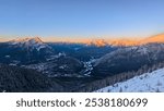 Sunset from the peak of Sulfur Mountain overlooking the townsite of Banff and scenic mountain ranges.