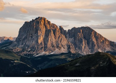 Sunset photo of Sassolungo and Sassopiato (Langkofel) mountian in Dolomites, Tyrol, Italy. High rock face in Dolomiti. Sunset over the alpine mountain landscape.