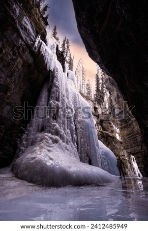 A sunset photography image of a frozen waterfall in Jasper National Park Canada
