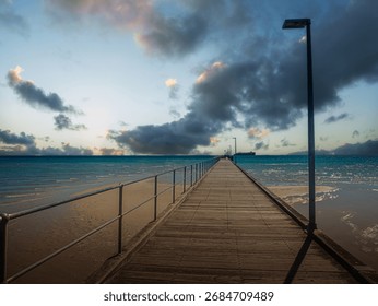 Sunset Pier With Passing Freighter