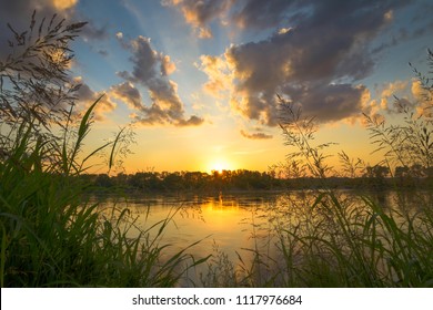 A sunset with rays and clouds over the Missouri River - Shutterstock ID 1117976684