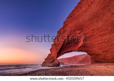 Sunset at red arches of Legzira beach, Sidi Ifni, Souss-Massa-Draa, Morocco.