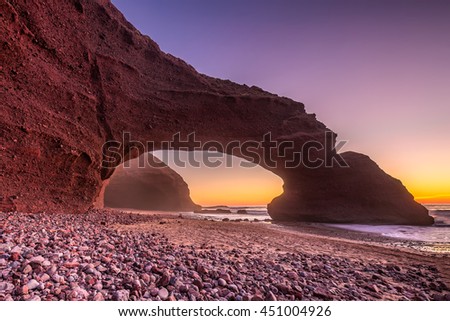 Sunset at red arches of Legzira beach, Sidi Ifni, Souss-Massa-Draa, Morocco.