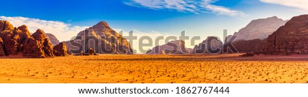 Sunset in the red desert with red rocks. Martian landscape.