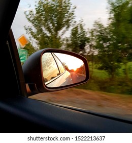 Sunset Reflected In Car Rearview Mirror