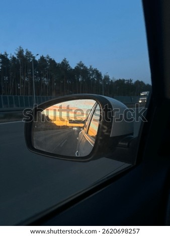 Sunset Reflected in Car Side Mirror While Driving on Highway