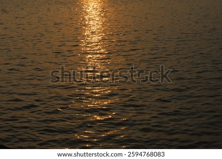 Sunset Reflected on the Ocean with Glimmering Waves and Shimmering Water.