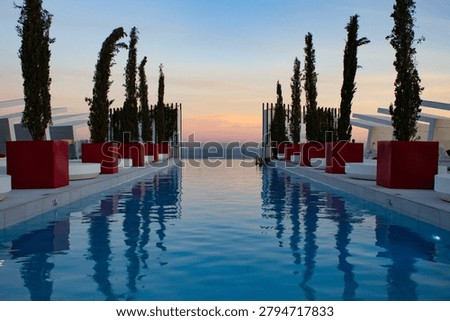 Sunset Reflected in Rooftop Infinity Pool hotel resort orange blue sky water swimming red reflection mirror image photo photograph editorial luxury trees plants symmetrical landscape png travel clouds hotel