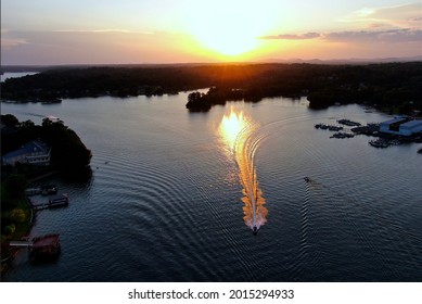 Sunset Reflection Chasing A Boat On Lake Hickory. 