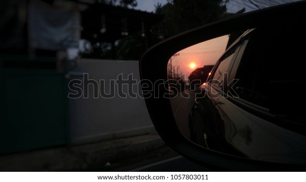 Sunset reflection in the\
mirror of car.