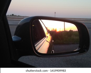 sunset reflection in the rearview mirror of a car on a summer evening (shot on the phone)