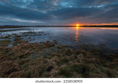 Sunset reflection in the water on a meadow in Czulczyce, eastern Poland - Powered by Shutterstock