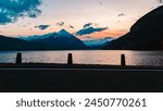 Sunset with reflections and the alps in the background near Merligen, Lake Thunersee, Sigriswil, Bern, Switzerland