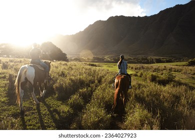 The sunset is riding a horse at Kualo Aranch Park in Hawaii - Powered by Shutterstock