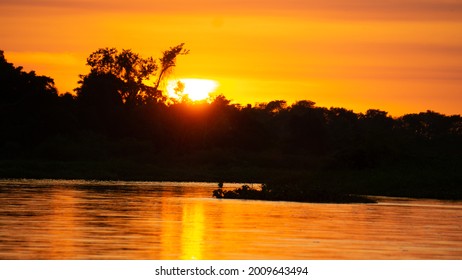 The sunset in a river in Brazilian Pantanal. May, 2021. - Mato Grosso, Brazil.