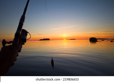 Sunset river perch fishing with boat and rod, hauntingly beautiful night, fish rising, evening bite, successful fishing and good trophy. Men's entertainment