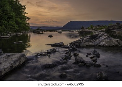 Sunset And Rocks On The Susquehanna River.